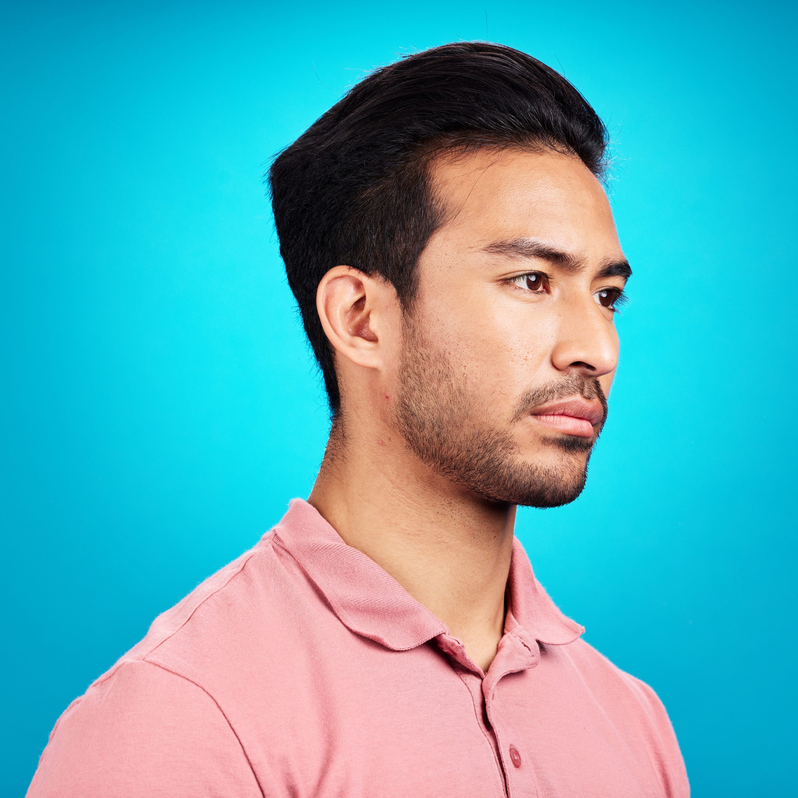 Thinking, serious and profile of Asian man in studio isolated on a blue background. Idea, side face.